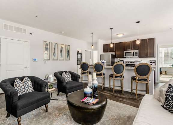 A living room with a black couch and a coffee table.