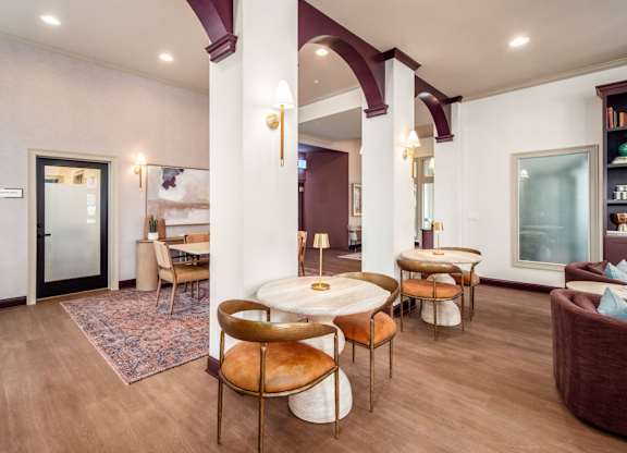 A living room with a round table and chairs.