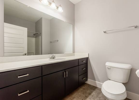 A white toilet sits next to a sink in a bathroom.
