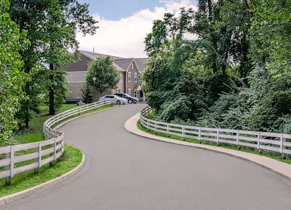 A car is parked on the side of a curvy road.