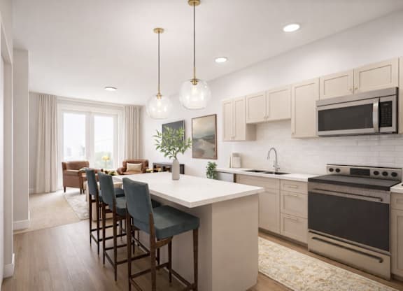 A modern kitchen with a large island and bar stools.