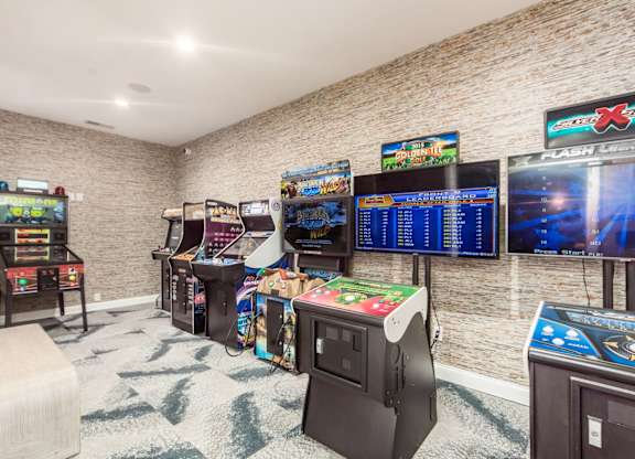 A room full of arcade games including a claw machine.