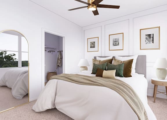 A bedroom with a large bed and a ceiling fan.