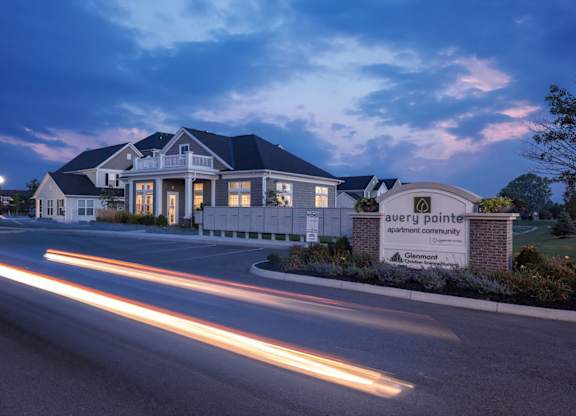 a house with a street in front of it at night