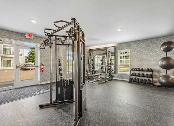 A gym with a weight rack and a mirror.