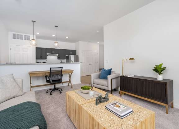 A modern living room with a wooden coffee table and a grey sofa.