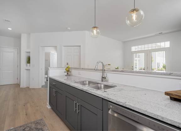 A kitchen with a sink and a window.