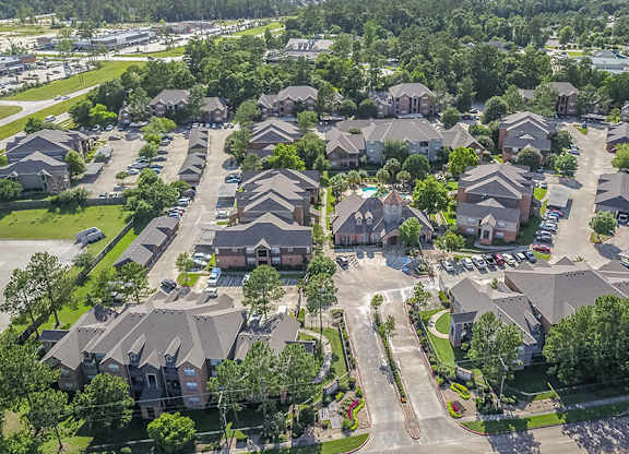 A bird's eye view of a residential neighborhood with houses and trees.