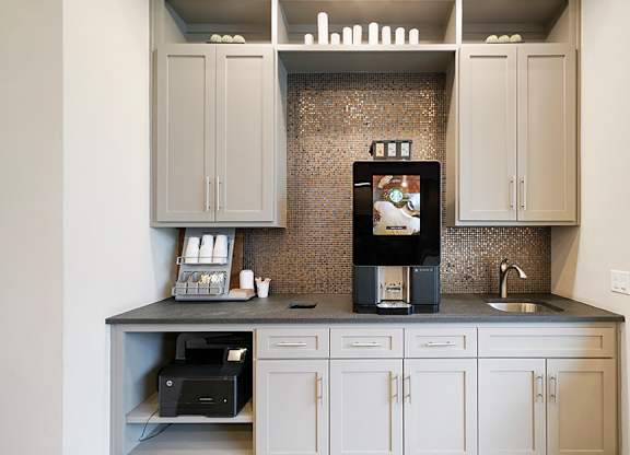 A kitchen with a microwave, oven, and sink.
