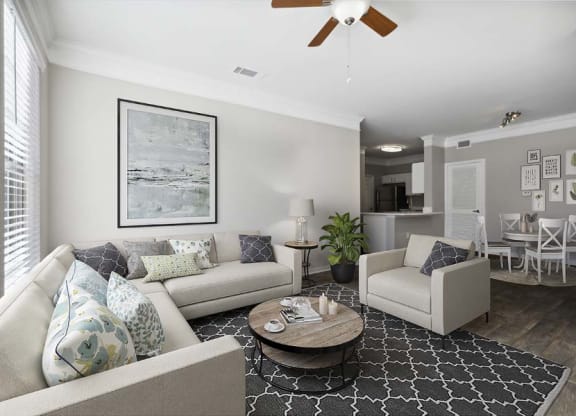 a living room filled with furniture and a ceiling fan