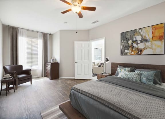 a bedroom with a large bed and a ceiling fan