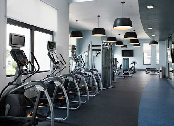 A gym with treadmills and other exercise equipment.