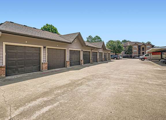 A row of garages with a clear blue sky above.