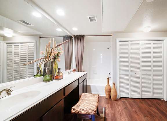A bathroom with a white sink and a white toilet.