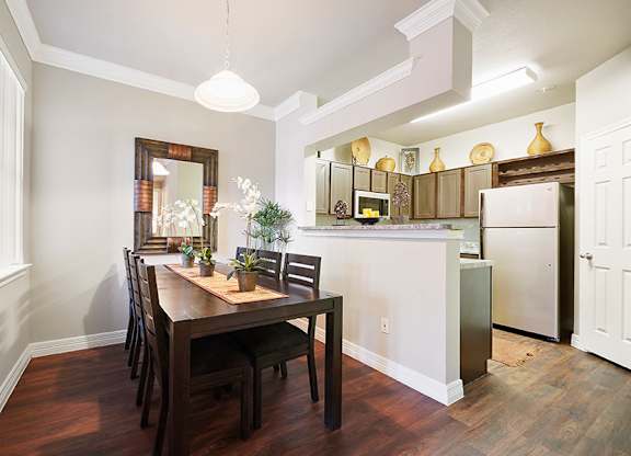 A kitchen with a table and chairs in the middle of the room.