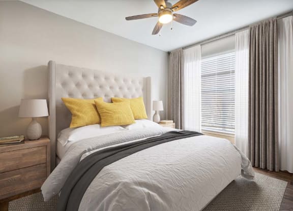a bedroom with a bed and a ceiling fan