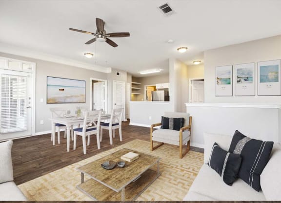 a living room filled with furniture and a ceiling fan