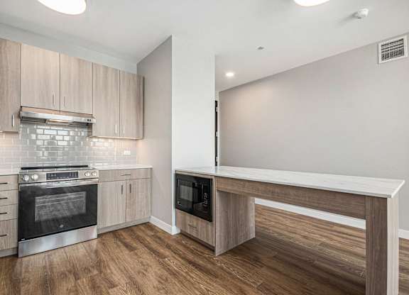 Fully equipped modern kitchen with wooden cabinets at Thrive Exchange, Chicago, IL, 60617