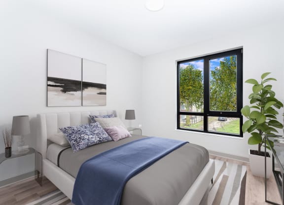 a bedroom with a bed and a large window