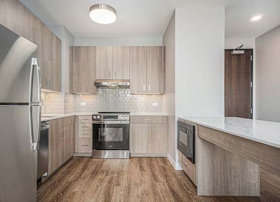 Stainless steel appliance in Modern kitchen with wooden cabinets at Thrive Exchange, Chicago, IL