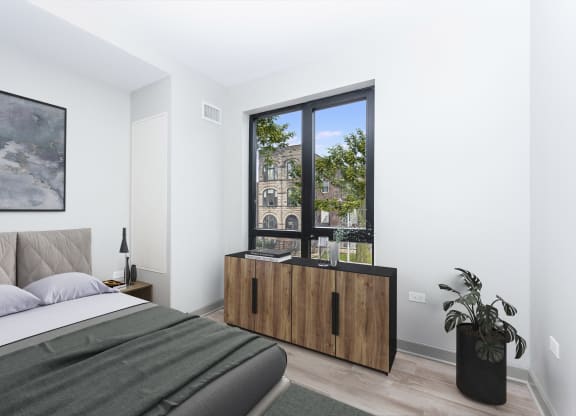 a bedroom with a bed and a large window