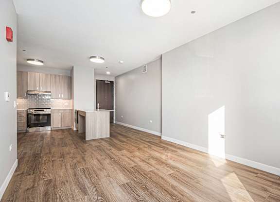 Spacious room with wooden flooring and a kitchen area at Thrive Exchange, Illinois , 60617