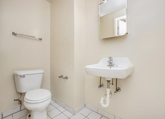 A white toilet and sink in a bathroom.