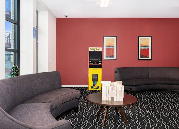 a living room with two couches and a coffee table with a machine