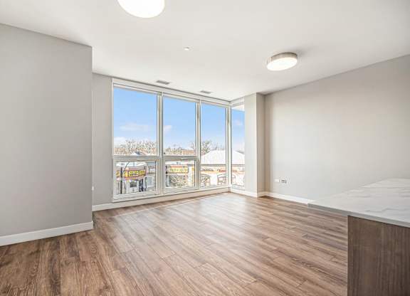 Living Room With Expansive Window at Thrive Exchange, Chicago, Illinois