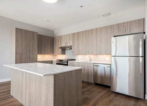 Modern kitchen with a marble countertop and stainless steel appliances at Thrive Exchange, Illinois , 60617