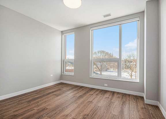 Room with a large window and wooden flooring at Thrive Exchange, Chicago, Illinois