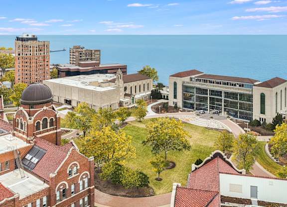 an aerial view campus with the ocean in the