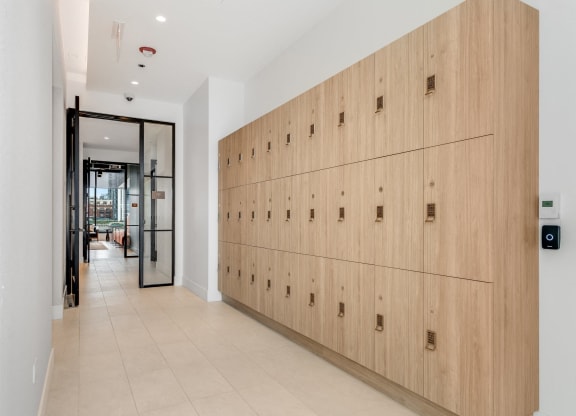 a long row of wooden lockers in a hallway of a building  at Cassidy on Canal, Chicago