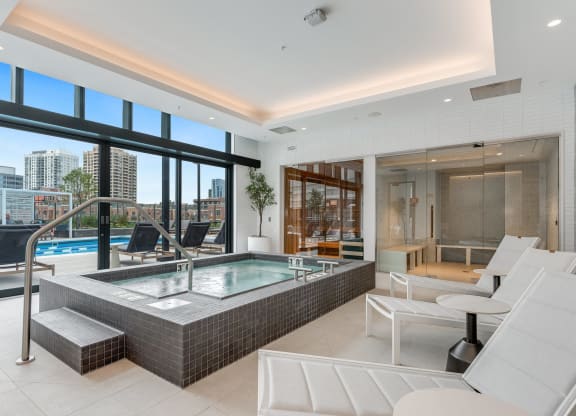 a spa area with a jacuzzi and a pool in a luxury apartment  at Cassidy on Canal, Chicago, 60606