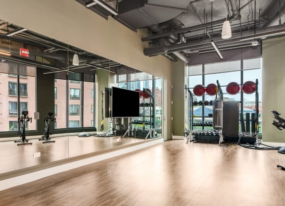 a workout room with a large window and gym equipment  at Cassidy on Canal, Chicago