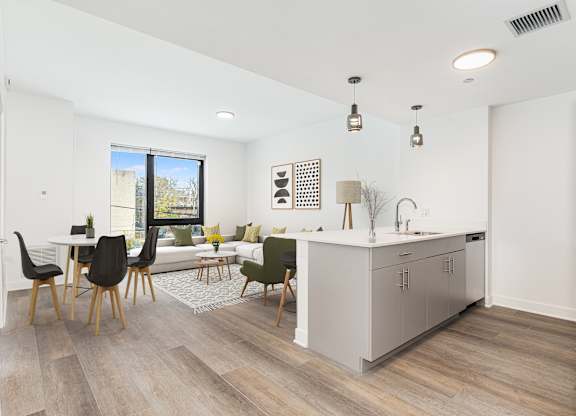 A modern kitchen with a dining table and chairs.