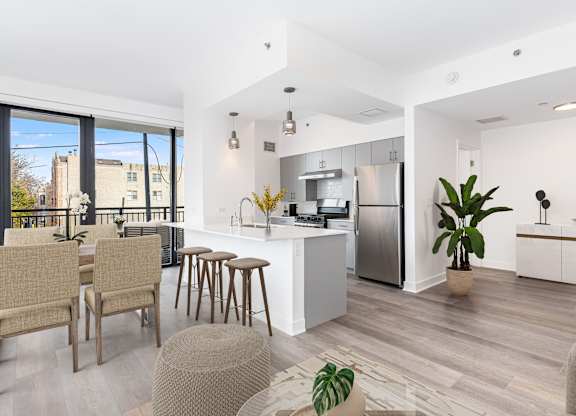 A modern kitchen with a dining table and chairs.