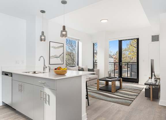 A modern kitchen with white cabinets and a large island.