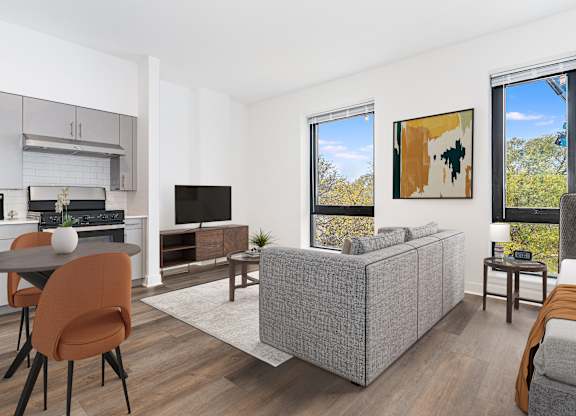 A modern living room with a grey sofa and a television.