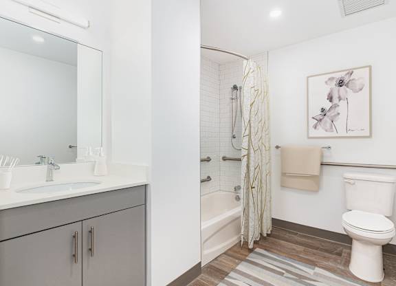 A bathroom with a toilet, sink, and shower.