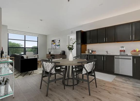 a kitchen and dining room with a table and chairs