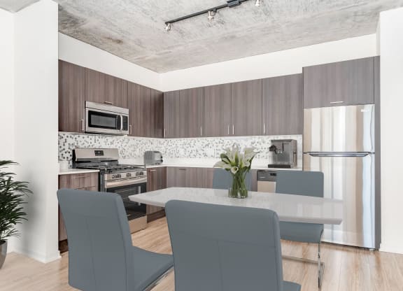 a kitchen and dining room with a table and chairs at One 333, Chicago, IL