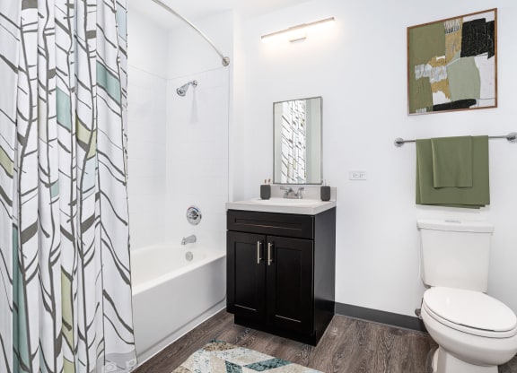 a bathroom with a shower and a toilet and a sink