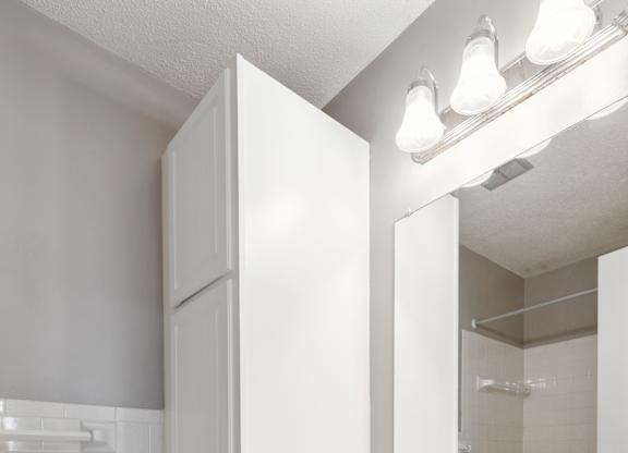 Bathroom vanity with white cabinets and storage at Cedarvale Highlands Apartments, Minnesota