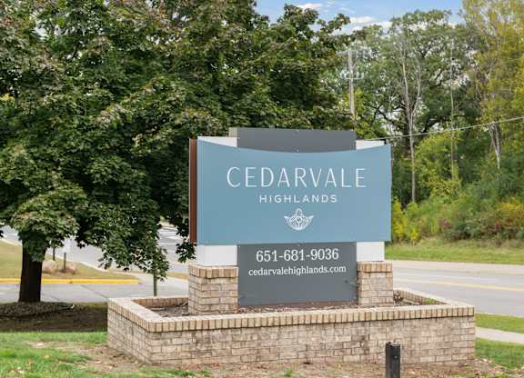 Property entrance sign with brick base at Cedarvale Highlands Apartments, Minnesota, 55122