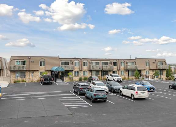 Apartment building exterior with parking lot at Cedarvale Highlands Apartments, Eagan, MN 55122
