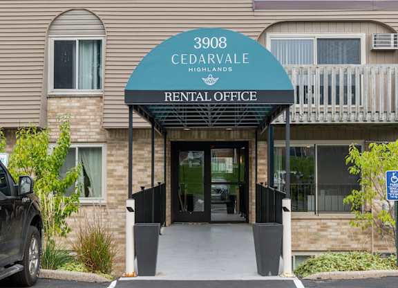 Rental office entrance with covered awning at Cedarvale Highlands Apartments, Eagan, Minnesota