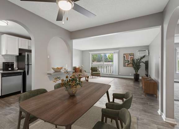 Open dining area with modern furniture and kitchen at Cedarvale Highlands Apartments, Eagan