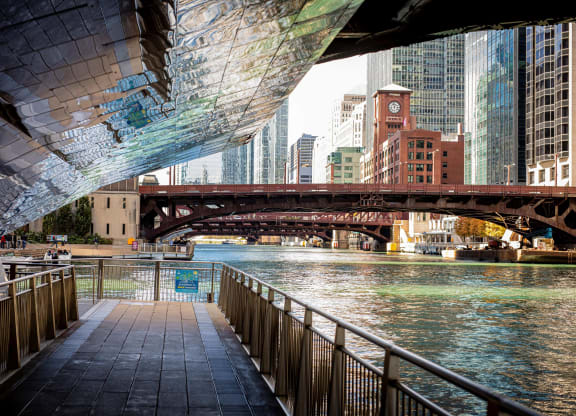 a bridge over the river in a city with skyscrapers at Columbus Plaza, Illinois, 60601