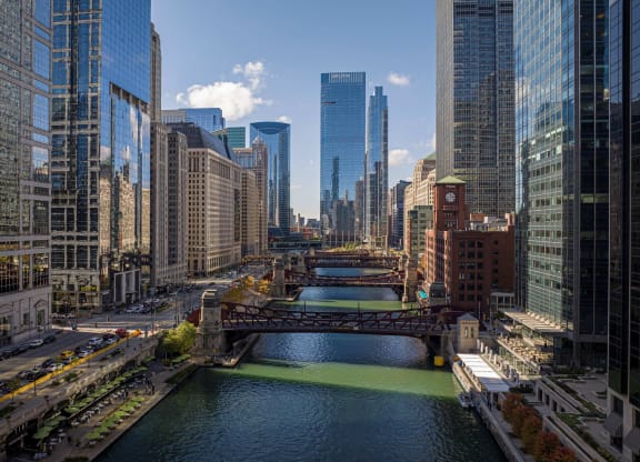 a view of the river with a bridge and skyscrapers at Columbus Plaza, Chicago, IL